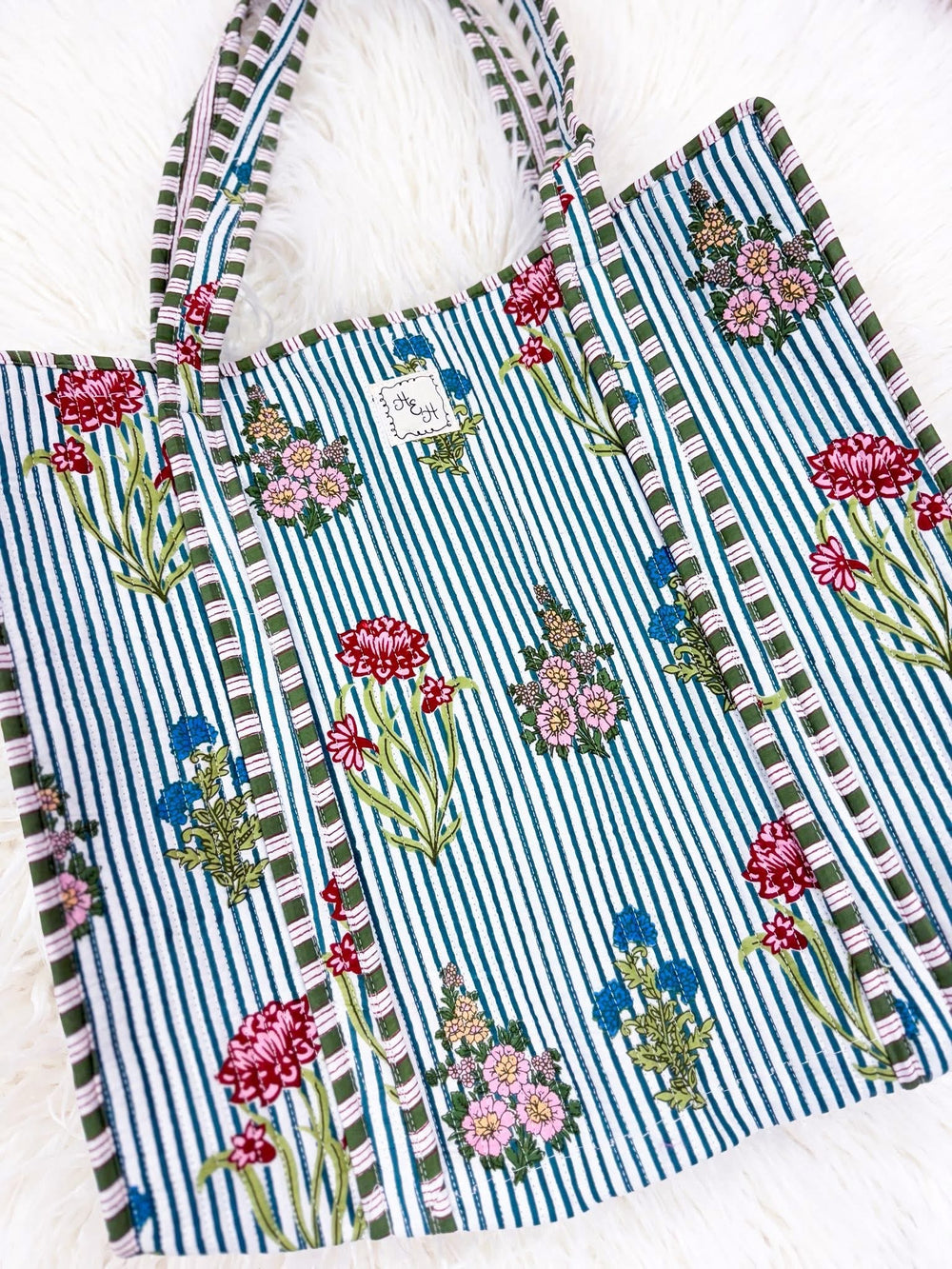 quilted striped tote bag with flower accents