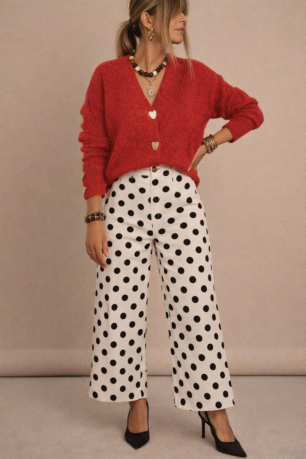 Woman wearing a red cardigan and polka dot pants 
