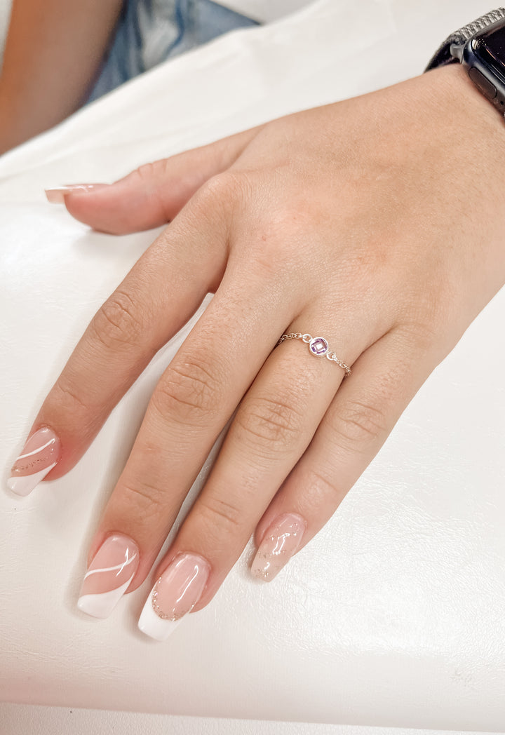 Hand wearing a permanent jewelry ring 