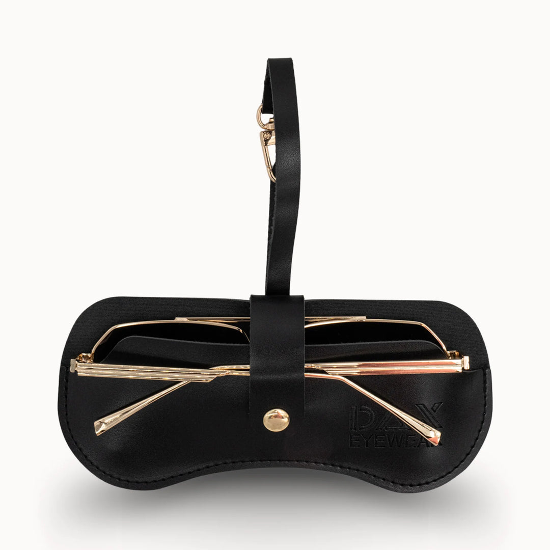 Black eyeglass case with gold-framed glasses on a white background