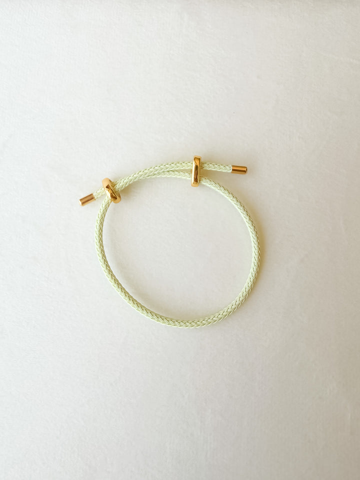 Light green  adjustable paracord bracelet with gold accents
