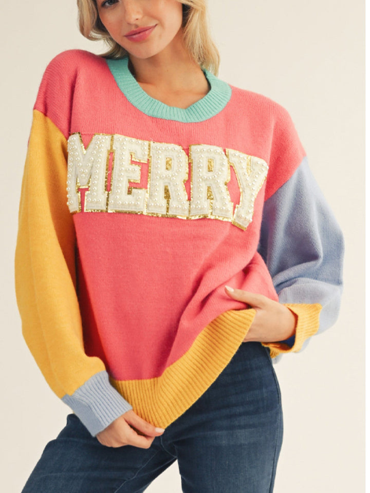 Woman wearing a colorful sweater with &
