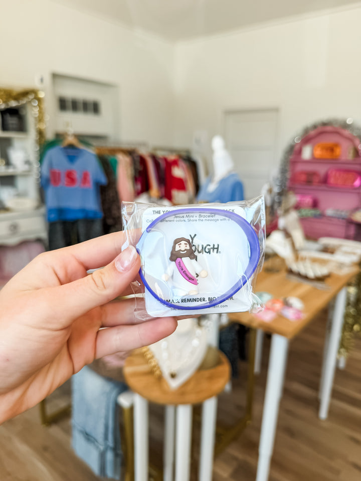 Mini Jesus figuring + Bracelet combo pack in purple in a boutique