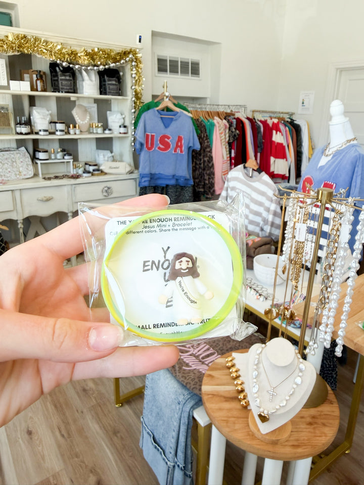 Mini Jesus figuring + Bracelet combo pack in yellow inside of Nocona boutique