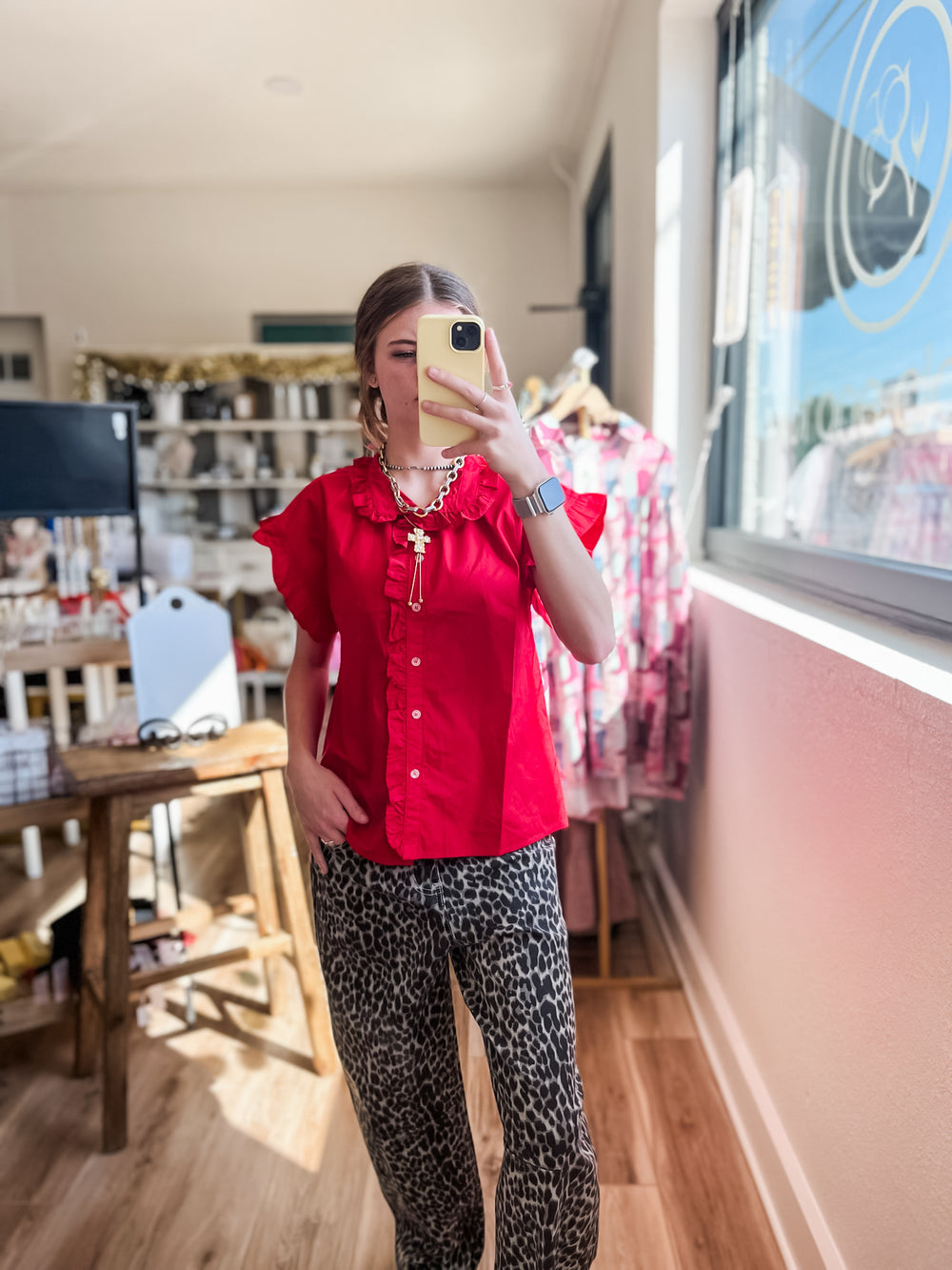 Women wearing red ruffle top with leopard pants