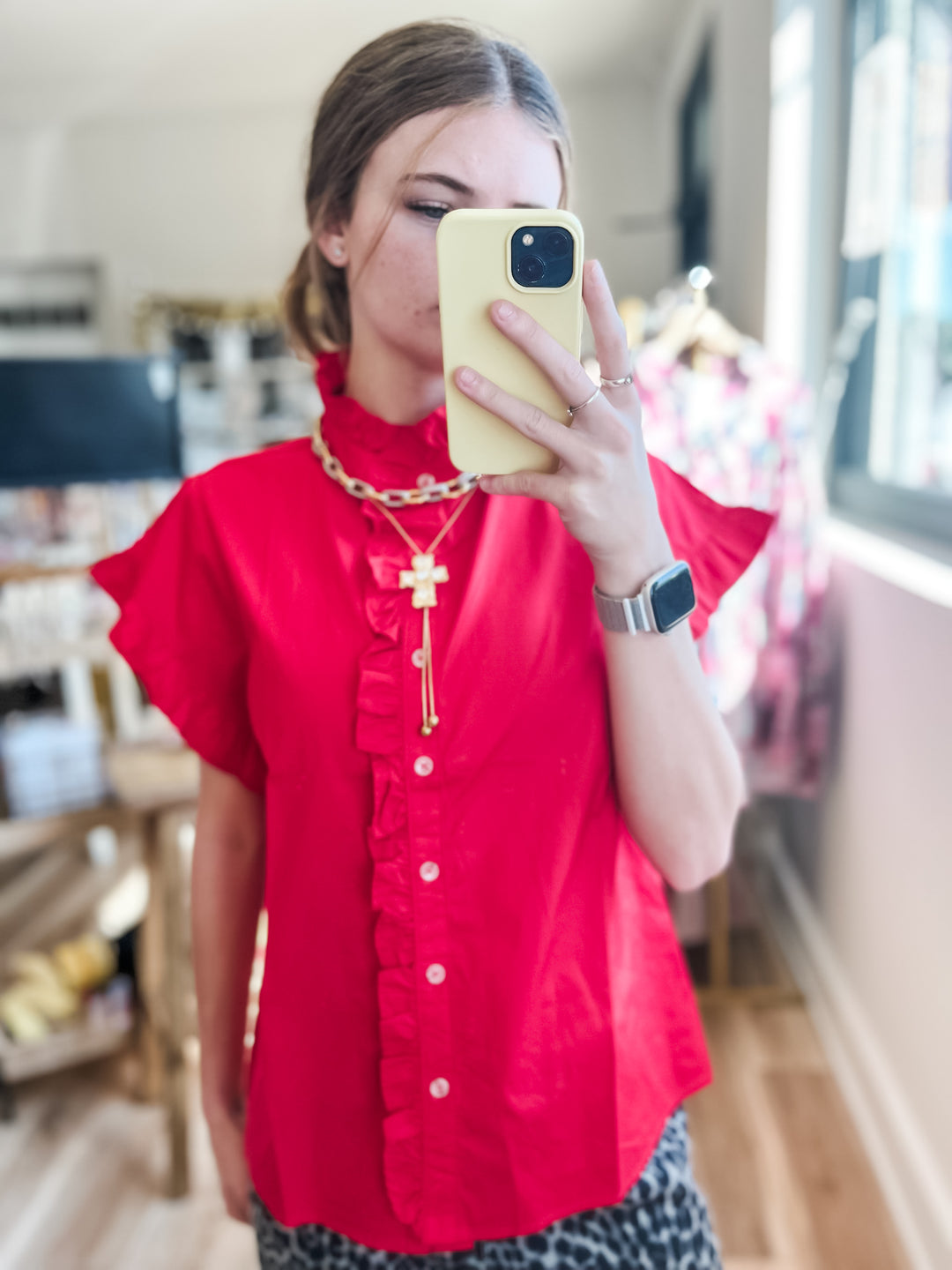 Women wearing red ruffle sleeve top 