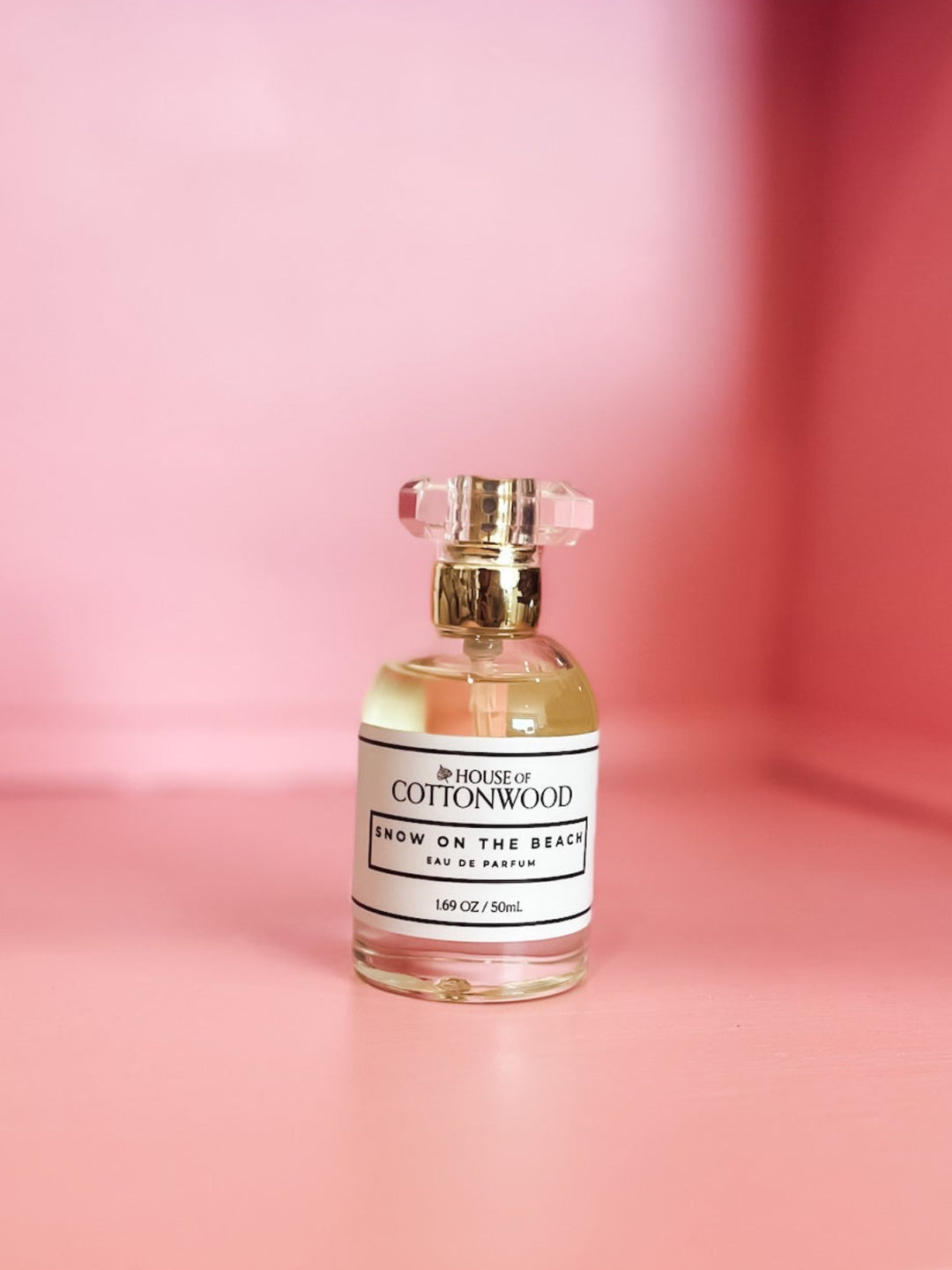 A small glass perfume bottle labeled &