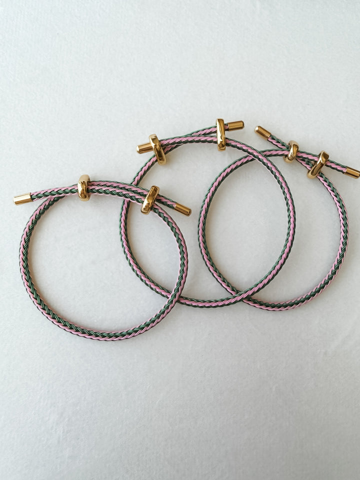 Three pink and green adjustable paracord bracelet with gold accents