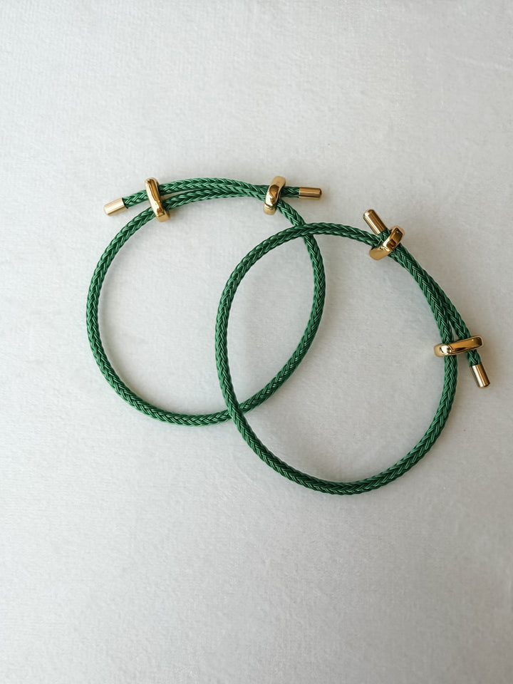 Two green adjustable paracord bracelet with gold accents