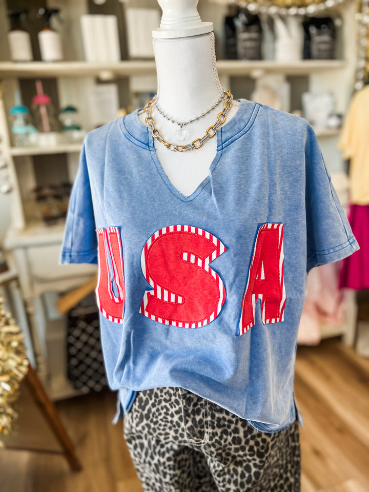 Mannequin wearing a blue t-shirt with &