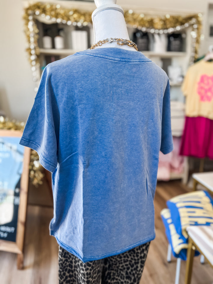 Mannequin wearing a blue t-shirt in a store setting