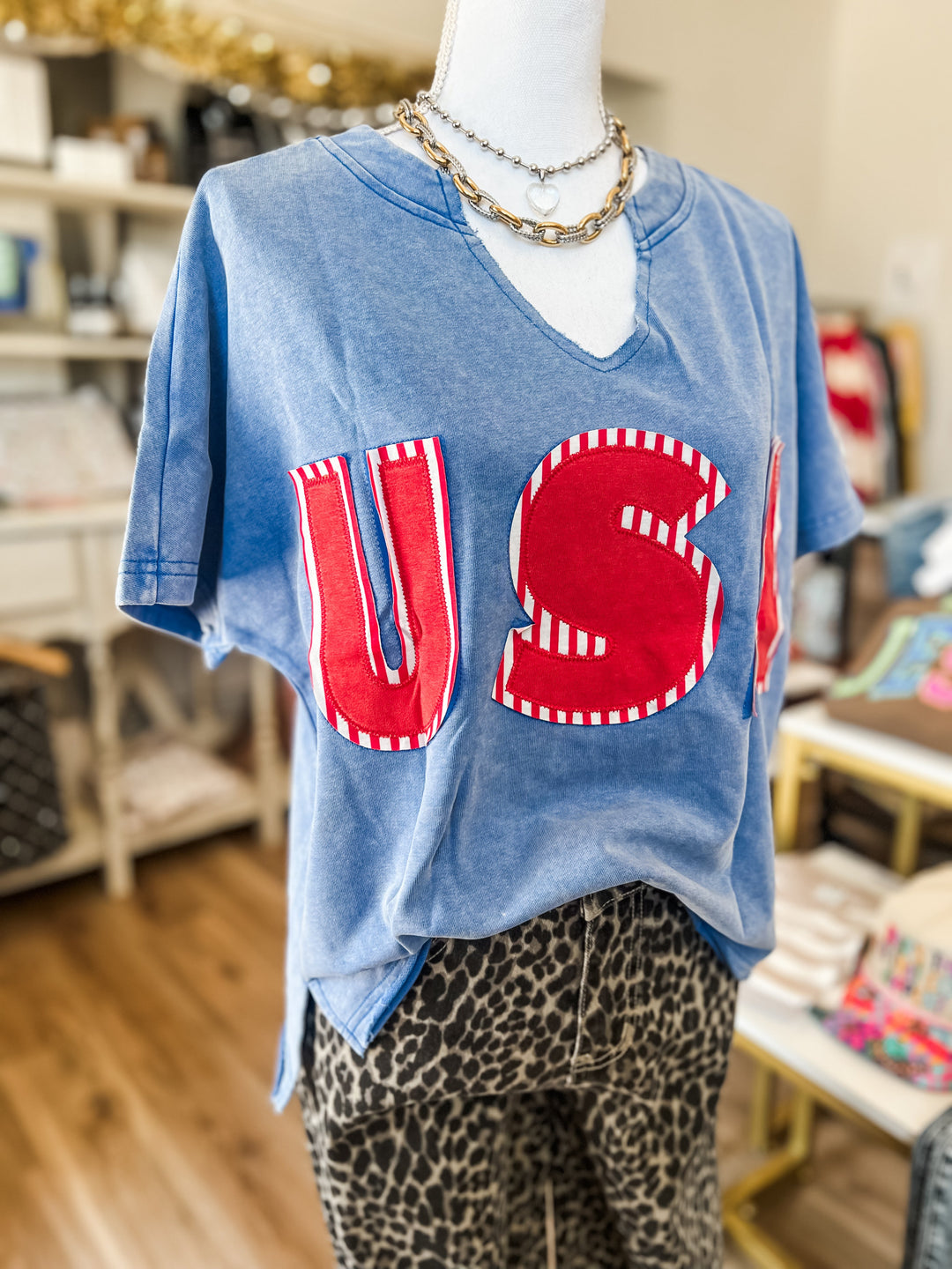 Mannequin wearing a blue oversized t-shirt with red &