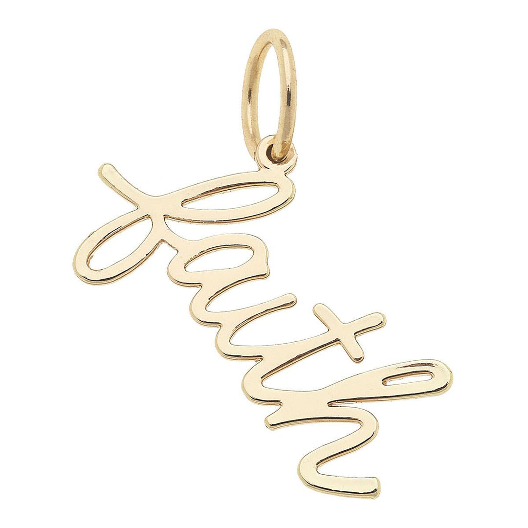 A shiny gold charm with the word 'faith' written in cursive script.
