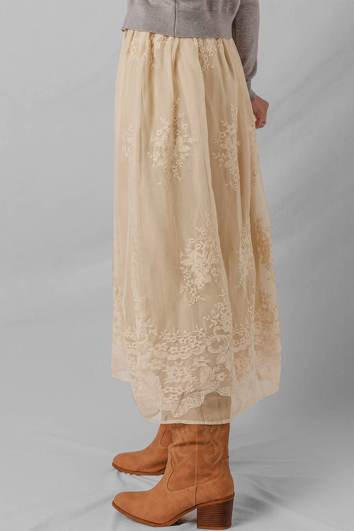 Woman wearing a beige lace skirt 