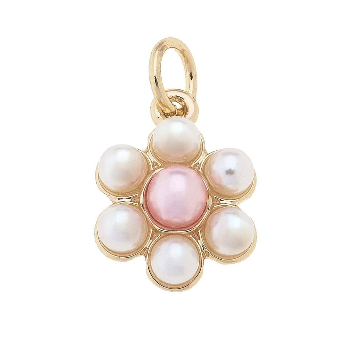 A gold-plated charm with a flower design, featuring a central pink pearl surrounded by white pearls.