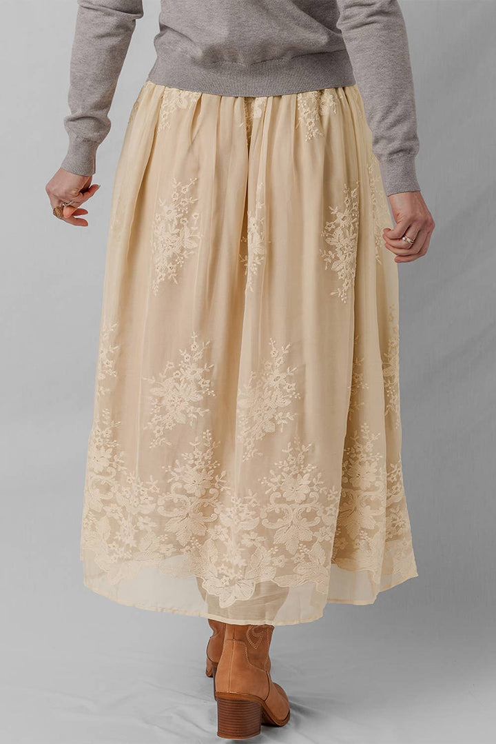 Woman wearing a beige lace skirt 