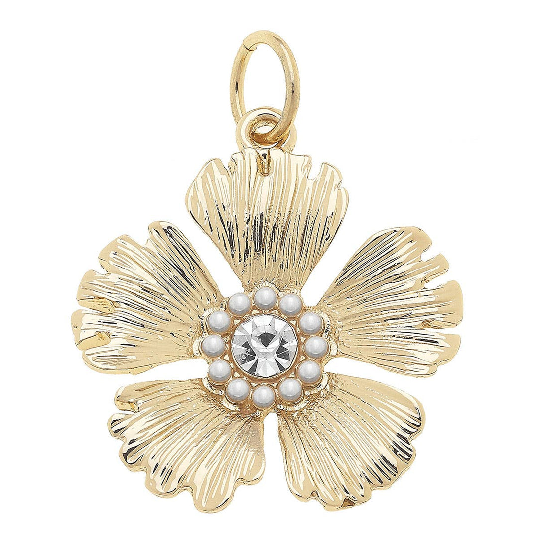A shiny gold floral charm with rhinestone embellishments