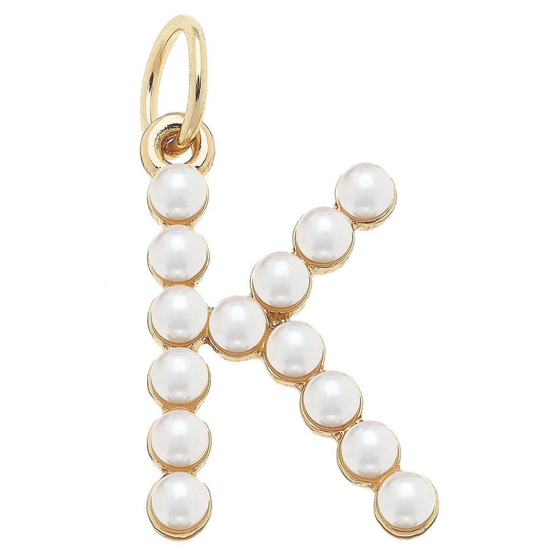A gold-plated letter charm 'K' adorned with white pearls.