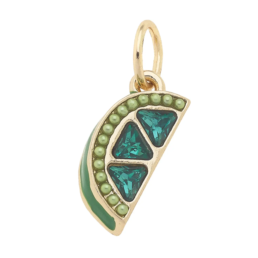 A gold-plated lime wedge-shaped charm with green enamel and pave stone detailing.