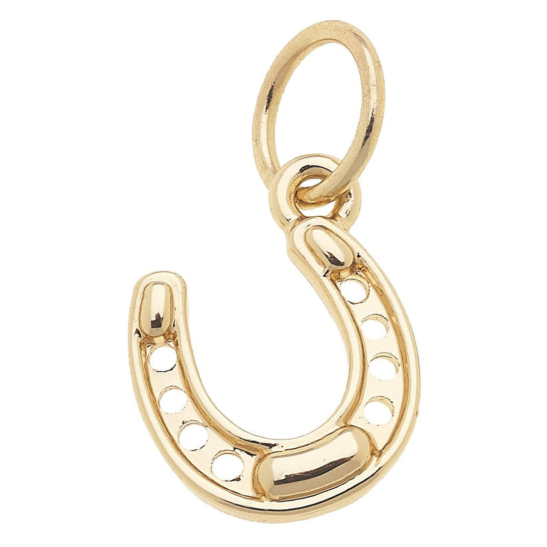 Gold horseshoe-shaped pendant charm on a white background