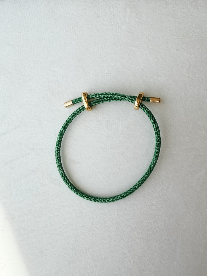 Green  adjustable paracord bracelet with gold accents
