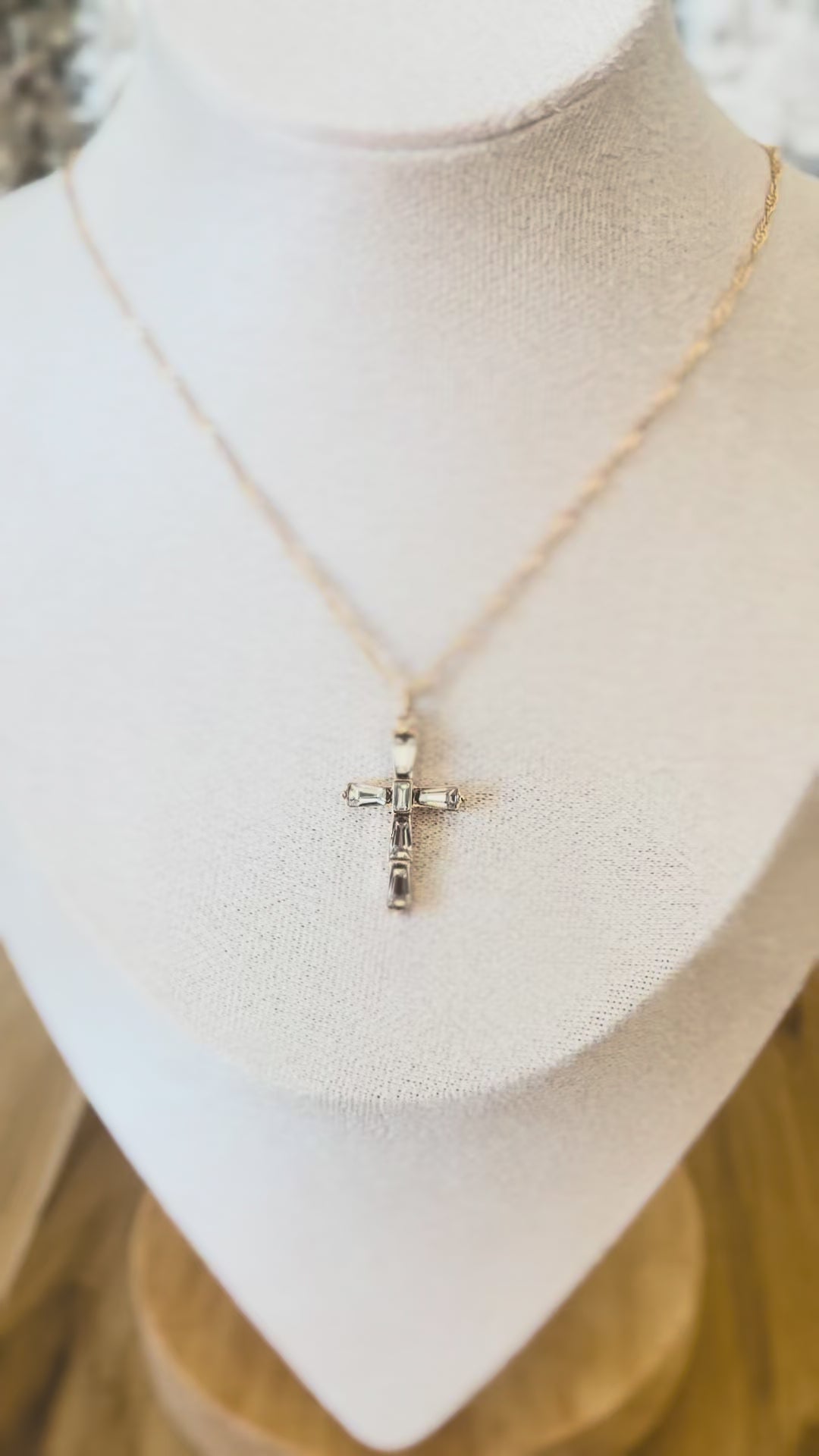Video of gold dainty necklace with a cross pendant