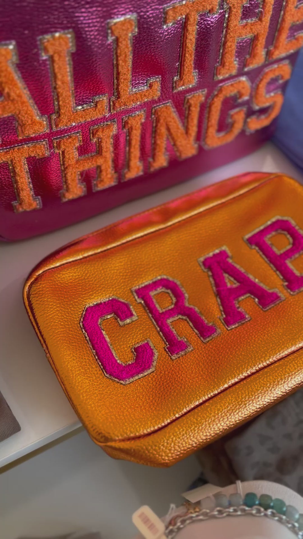 Video featuring cosmetic bags with text"Crap" and "all the things"
