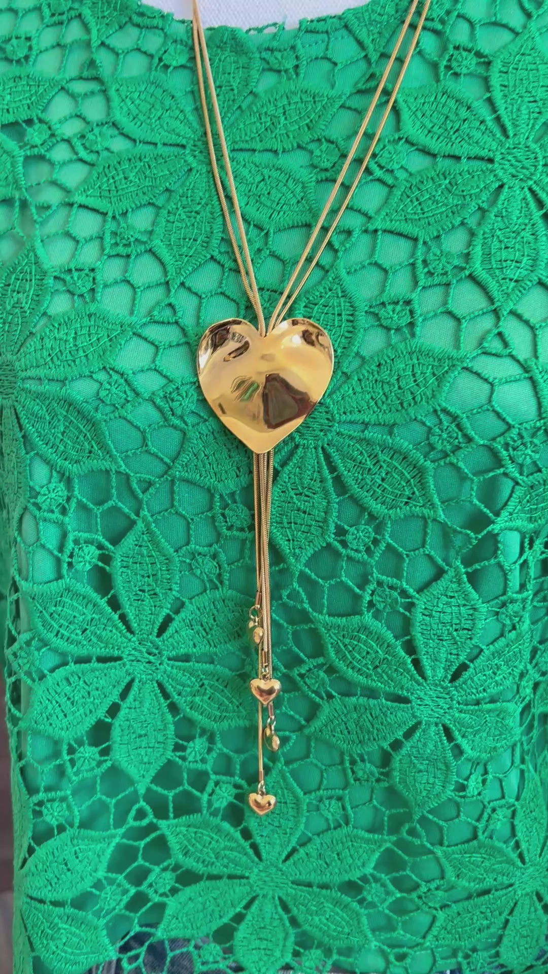 video of a gold waterproof bolo like necklace with a heart 