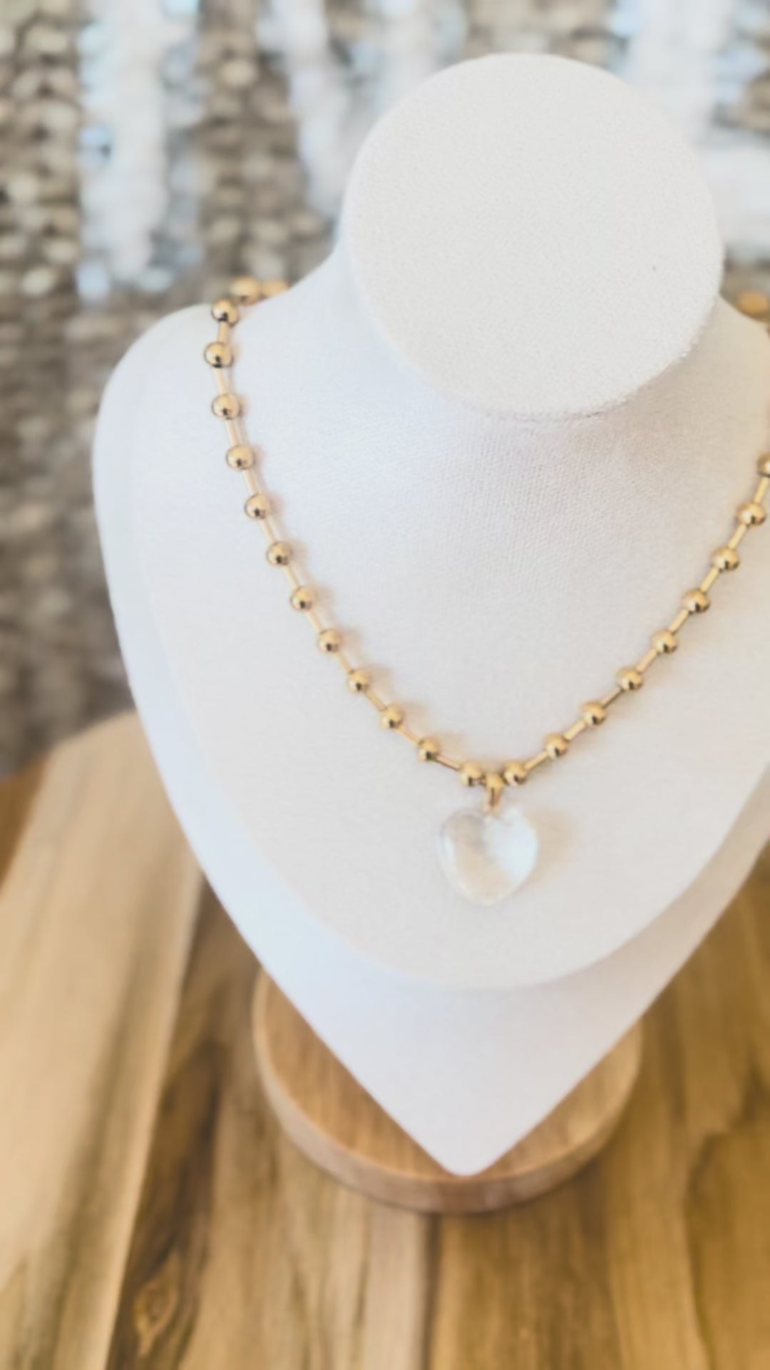 Clear hearth pendant on gold necklace