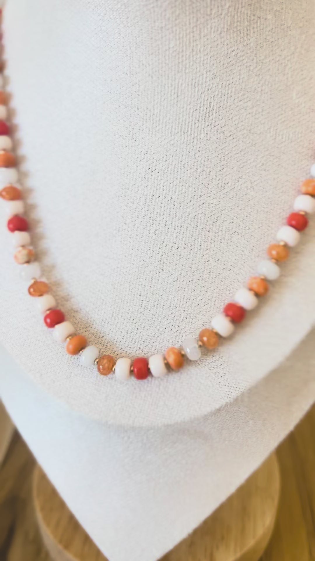 Video of orange and white beaded necklace